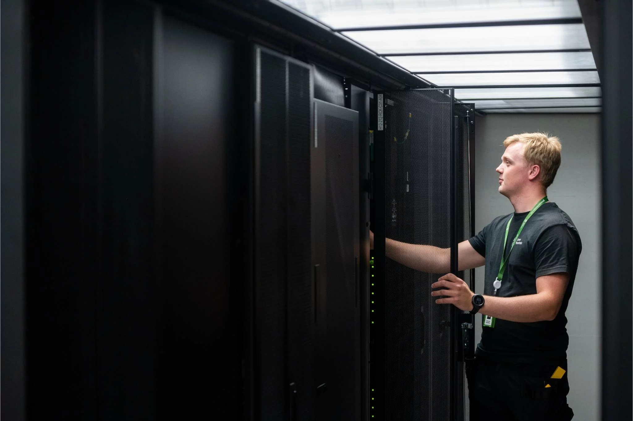 Data Center Technician checking a sensor