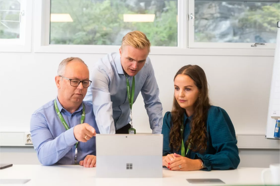 Green Mountain Employees with a computer